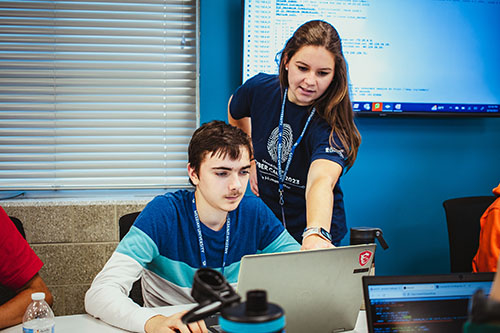 Emily Anderson with male student at Cyber Camp