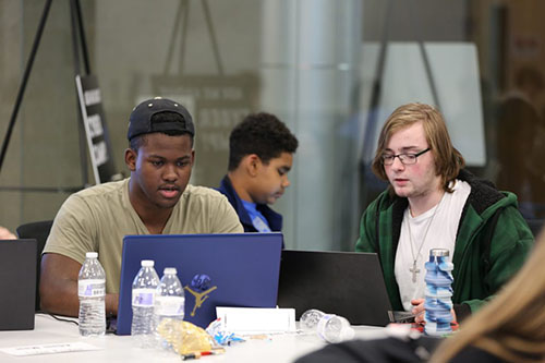 Students working on their laptops at Cyber Camp