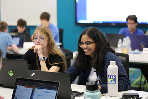 Two female cyber campers at their computers