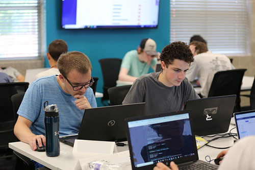 Cyber campers working at laptops