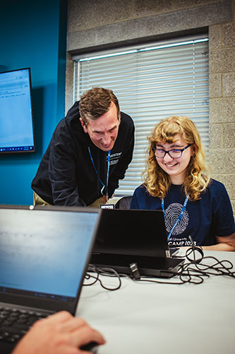 Lynn Bigelow with a student at Cyber Camp