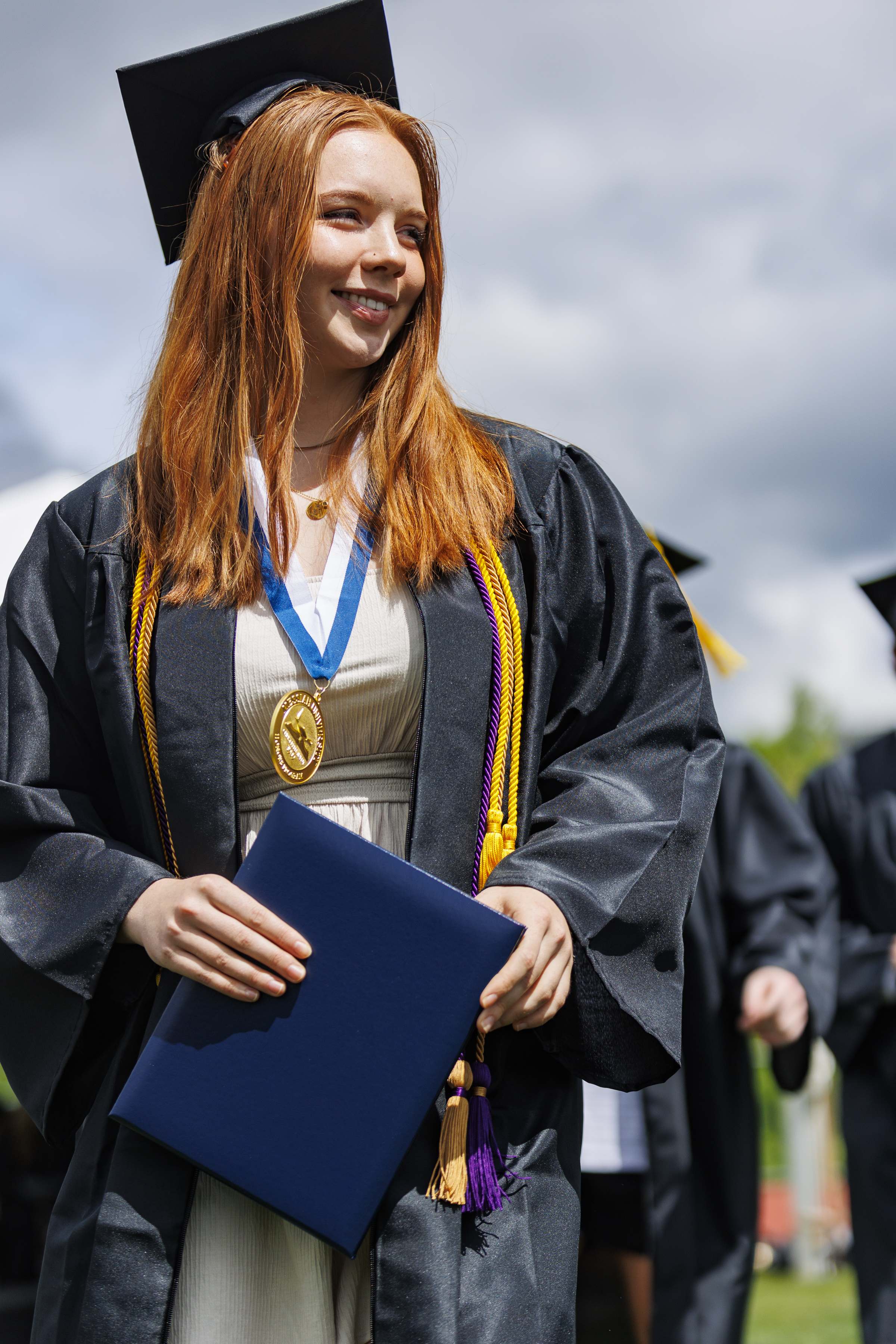 Student standing at graduation