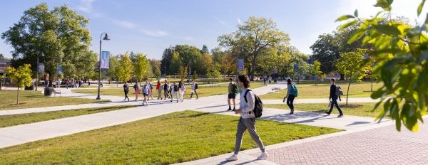 Student walking on the sidewalk at Messiah University