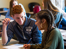 A male and female student studying together